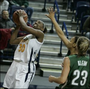 University of Toledo's Tanika Mays drives past Cleveland State defenders to finish off a Rocket fast break with a layup.