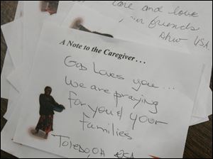 CTY kits23p  11/22/2009    Blade Photo/Lori King  Hand-written notes of encouragement are put in each of the 200 volunteer caregiver kits assembled at St. Joseph Catholic Parish Community Center Gymnasium in Maumee, OH.