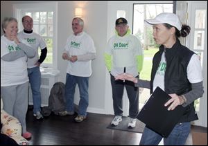 Margaret Rodriguez, right, talks to other opponents of the deer cull, all wearing their opposition T-shirts. From left are Cathy Appleby, Michael Eisenstodt, Jim Jenkins, and Clyde Appleby. Retired Ohio Supreme Court Justice Alice Robie Resnick shows deer repellents she uses in her yard in Ottawa Hills. She opposes the village proposal to hire a firm to kill up to 50 deer.