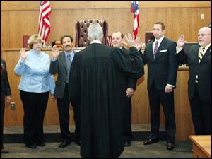 Slug: CTY oregon30p                       Date 11/29/2009           The Blade/ Amy E. Voigt                   Location: Oregon,  Ohio NOTE TO DESK: Mr. Peach was not there.  CAPTION:   Judge Jeffrey Keller of Oregon Muncipal Court, center, swears-in Oregon City Council members from left: Michael Sheehy,  Sandy Bihn, James Seaman, Dennis Walendzak, Clint Wasserman, and Terry Reeves during a ceremony on November 29, 2009.  There will be  a farewell luncheon and open house for Marge Brown, who was mayor of Oregon for eight years, at 12:30 p.m. Monday in City Council Chambers, 5330 Seaman Road.