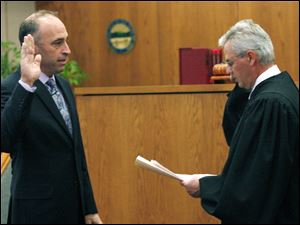 Slug: CTY oregon30p                       Date 11/29/2009           The Blade/ Amy E. Voigt                   Location: Oregon,  Ohio  CAPTION:   Judge Jeffrey Keller of Oregon Muncipal Court, right,  swears-in ceremony Mayor Michael Seferian, left, during a ceremony  on November 29, 2009.  There will be  a farewell luncheon and open house for Marge Brown, who was mayor of Oregon for eight years, at 12:30 p.m. Monday in City Council Chambers, 5330 Seaman Road.