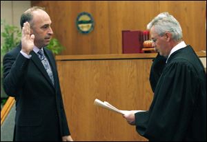 Slug: CTY oregon30p                       Date 11/29/2009           The Blade/ Amy E. Voigt                   Location: Oregon,  Ohio  CAPTION:   Judge Jeffrey Keller of Oregon Muncipal Court, right,  swears-in ceremony Mayor Michael Seferian, left, during a ceremony  on November 29, 2009.  There will be  a farewell luncheon and open house for Marge Brown, who was mayor of Oregon for eight years, at 12:30 p.m. Monday in City Council Chambers, 5330 Seaman Road.