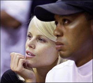 Tiger Woods says his wife, Elin, seen with him at a basketball game in Orlando in June, 'acted courageously when she saw I was hurt and in trouble. She was the first person to help me.'