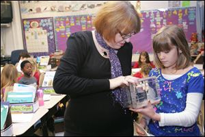 Teacher Judy Herr and 8-year-old Gwendolyn Pyle check on the progress of the butterflies in their Whiteford Elementary School classroom.
<br>
<img src=http://www.toledoblade.com/graphics/icons/photo.gif> <font color=red><b>VIEW</font color=red></b>: <a href=