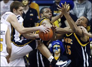Toledo's Jake Barnett, left, fights for a rebound with the Retrievers' Robbie Jackson, right, Saturday afternoon at Savage Arena.