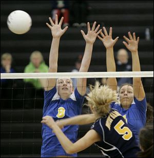 St. Ursula's Maggie Burnham, left, and Erin Williams try to block a shot by Notre Dame's Paige Roback. Burnham and Roback were both named to the All-City volleyball fi rst team.