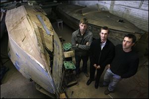 Ramsey brothers, Scott, Chris, and Dave, from left, have established a business restoring wooden-hulled boats in Toledo. They hope to resurrect an entire line of Dart speedboats. 