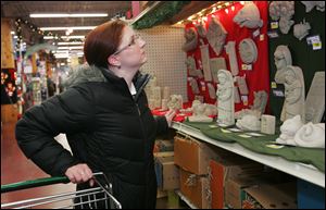 Shopping at The Andersons, Amelia Contreras of Toledo considers items from the Carruth Studios of Waterville. 