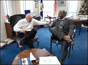 Toledo Mayor Carty Finkbeiner shares a laugh with his successor, Mike Bell, as the pair meet in the mayor's office on the 22nd floor of One Government Center. The two met yesterday morning to discuss the transition between the two administrations. Mr. Bell was elected in November and is to take the oath of office Monday. Mr. Finkbeiner did not seek re-election.