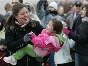 Kristy Weaver of Sylvania dances with her daughter, Ava, 3, as the ball ends its descent. Those attending the zoo's celebration could make a few ReZOOlutions to be a little greener in 2010, watch an ice carving demonstration, or make crafts.
