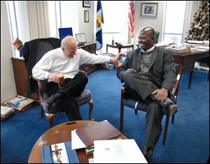 Toledo Mayor Carty Finkbeiner shares a laugh with his successor, Mike Bell, as the pair meet in the mayor's office on the 22nd floor of One Government Center. The two met yesterday morning to discuss the transition between the two administrations. Mr. Bell was elected in November and is to take the oath of office Monday. Mr. Finkbeiner did not seek re-election.