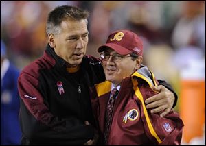 This is an Oct. 26, 2009, file photo showing Washington Redskins head coach Jim Zorn, left, greeting team owner Dan Snyder before an NFL football game against the Philadelphia Eagles, in Landover, Md. Zorn was fired by the Washington Redskins early Monday, Jan. 4, 2009, the first step in yet another team overhaul under owner Dan Snyder.