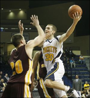 The Rockets' Jake Barnett puts up a shot over Central Michigan's Robbie Harman. Barnett was Toledo's high scorer with 19 points.