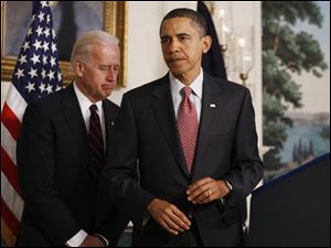President Barack Obama, accompanied by Vice President Joe Biden, finishes a statement about the earthquake in Haiti, Wednesday, Jan. 13, 2010, at the White House in Washington.