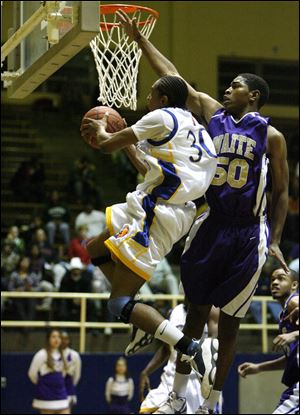 Libbey's Maurice Taylor soars past Waite's Antonio Allen for a basket. Taylor had 18 points.