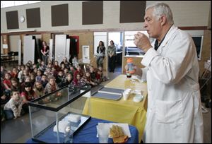 Herm Dunwald of Toledo, also known as ‘Professor Ray,' uses dry ice to make a point to the children at Wayne Trail. Mr. Dunwald is a former junior high and senior high science teacher who has been a presenter at the former COSI-Toledo. His presentation Thursday showed the youngsters how matter changes.