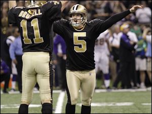 Garrett Hartley (5) of New Orleans celebrates with Mark Brunell after kicking the game-winning field goal to lift the Saints past Minnesota in overtime last night in the Superdome.