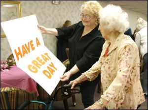Slug:  CTY edna26p                    Date 1/25/2010           The Blade/ Amy E. Voigt                    Location: Toledo, Ohio  CAPTION:   Diane Woodard, left, Resident Council President, shows  Edna Sandys (cq) , right, a special birthday card during her 101st. surprise birthday party at Lakewood Apartments on January 25, 2010.