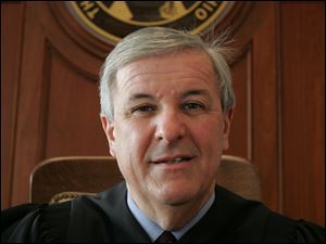 The court did not say if Judge Kenneth P. Muehlfeld, left, of Henry County, should proceed with the trial on Monday.