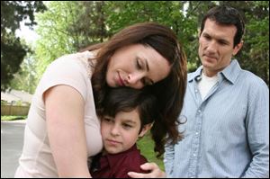 In a scene from the Christian movie ‘No Greater Love,' Jeff Baker
(Anthony Tyler Quinn) and son Ethan (Aaron Sanders) are reunited with Heather Stroud-Baker (Danielle Bisutti).