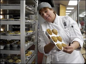 Kelley Bryan checks her muffins in a cooking class. She entered the school after spending three months looking for a job and deciding to retrain for a new career.