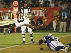 New Orleans running back Pierre Thomas leaps into the end zone during the second half of the Super Bowl. 