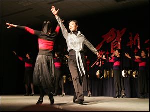Amy Chen, left, of Toledo and Jessica Xie of Perrysburg, both of the Chinese Association of Greater Toledo, perform the Butterfly Lovers dance during annual Spring Festival festivities at the University of Toledo. 