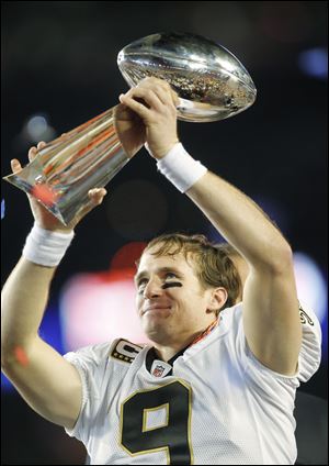 Drew Brees hoists the Vince Lombardi Trophy in triumph after the quarterback led the New Orleans Saints over the Indianapolis Colts.