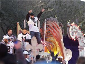 Super Bowl MVP Drew Brees salutes fans as the Saints take a victory march through New Orleans.