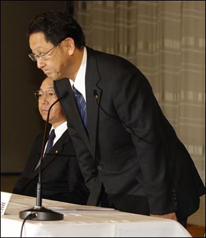 Toyota President Akio Toyoda bows as he makes a statement at a news conference in Tokyo. At left is Shinichi Sasaki, who oversees quality control.  