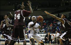 Scott's Dashawn Lee (24) blocks the path of Libbey's Brandon Underwood in a game Friday night.