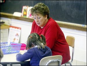 Sandy Huhn leads a kindergarten class at Little Flower. Thirty years ago, such classes were typically taught by nuns. Today, most Catholic teachers are lay people.