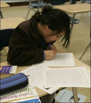 Neera Martin of St. Pius X School, writes with concentration.