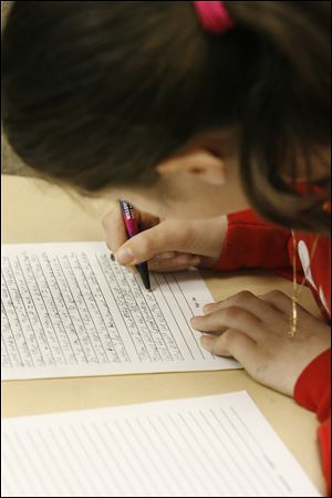 Jillian Fournier of Our Lady of Perpetual Help School writes on deadline in the competition at Springfield High School.