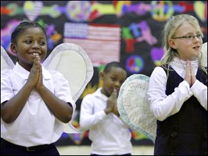 Slug: CTY program20p Date:  02192010     Andy Morrison       Location: Toledo Caption: Marvin Burwell, left, and Taylor Tennant, right, sing a song about angels with fellow second graders during a Black History Month program at Old West End Academy, Friday, 02192010. Summary.