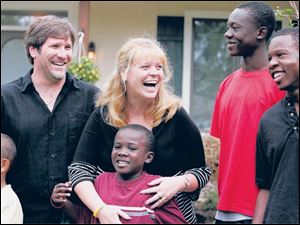 Aaron and Jackie Frisch with children Mikail, left, Charlie, Max, and Joe in 2008 during a ceremony outside their new
‘Exreme Makeover: Home Edition' house in Toledo.