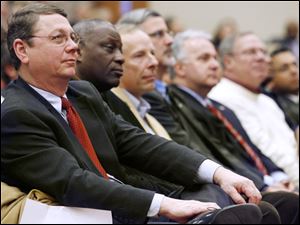 From left, Toledo City Councilmen Rob Ludeman, Michael Ashford, Tom Waniewski, Steven Steel, George Sarantou, D. Michael Collins, and Adam Martinez listen to Mayor Bell's address.