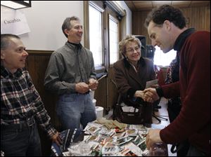 At Wildwood Metropark's Seed Swap, volunteers Bob Avery, from left, and Dale Theis chat with Rep. Marcy Kaptur (D., Toledo) and Michael Szuberla of Toledo GROWS.
