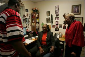Ms. Amison-Lewis, right, jokes with collegues Raymond Johnson of AmeriCorps and Mattie McAlister, educational coordinator for Grace Community Center.