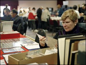 Slug: CTY stamp01p Date:  02282010     Andy Morrison       Location: Toledo  Caption: Joanne Haag, Cincinnati, pours through a stack of postcards at the 86th Annual Toledo Stamp Expo '10, at Holland Gardens, Sunday, 02282010. Summary.