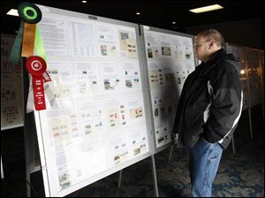 Slug: CTY stamp01p Date:  02282010     Andy Morrison       Location: Toledo  Caption: Dave Weber, Toledo, looks at a display of stamps featuring Japanese National Parks at the 86th Annual Toledo Stamp Expo '10, at Holland Gardens, Sunday, 02282010. Summary.