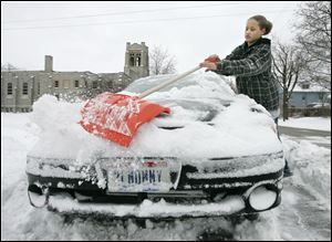 Mannoleto Gilmore, 14, cleared the family car on Delaware Avenue in central Toledo on Feb. 10, in
the midst of a month that produced the second-highest snowfall for any February on record.