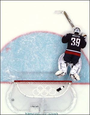 U.S. goalie Ryan Miller lies on the ice after giving up the game-winning goal to Sidney Crosby.