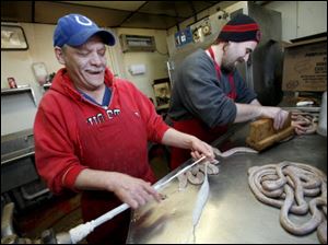 Mike Koscielski, left, and Ken Sheets make landjagers at Takacs Grocery & Meats in East Toledo. 