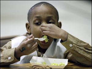 Quincy Harris is a bit hesitant as he samples some green eggs and ham during a celebration of the late Dr. Seuss' birthday at Riverside Elementary. Fifth graders at the school yesterday also made ‘Cat in the Hat'-style headgear and read stories by Theodor Seuss Geisel, who was born March 2, 1904, and wrote and illustrated 44 children's books before his death in 1991.
