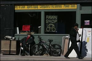 ROV sunny side   03/03/2010       The Blade/Lori King  Volunteer Standard Loan security worker Larry Cicak, left, sits in the sun in front of the downtown Toledo, OH pawn shop.