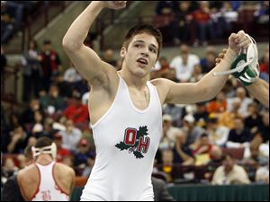 Oak Harbor junior Ian Miller
celebrates his Division II state title in the 145 pound weight class. Miller recorded a 19-4 technical fall over Dylan Ice of Lisbon Beaver Local in the championship match last night at Ohio State's Schottenstein Center.