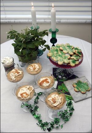 Dessert includes servings of Irish Coffee Caramel Mousse, foreground, a cup of Irish coffee, and cookies.