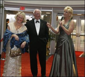 Right, WTOL anchor Chrys Peterson, right, welcomes Cary, left, and Dave Wise to the Oscar-themed event.