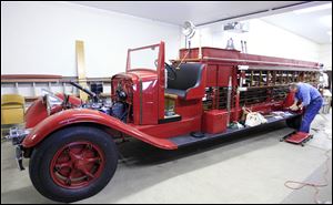 Retired firefighter Frank Dobrosky works to restore the 1933 ladder truck that served the Toledo Fire Department for some three decades, then sat waiting for restoration for many years. 